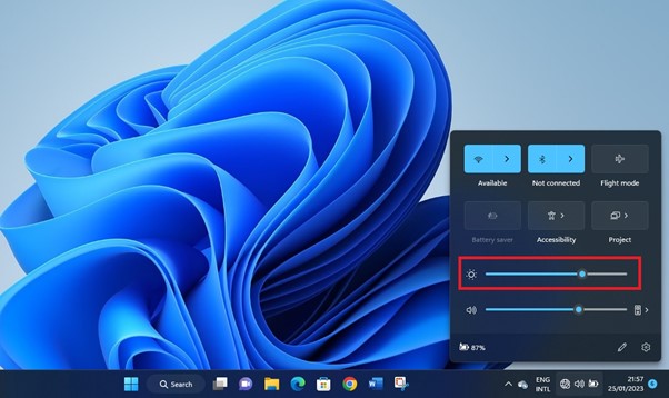 The slider to drag backward to reduce screen Brightness on Windows 11 specified