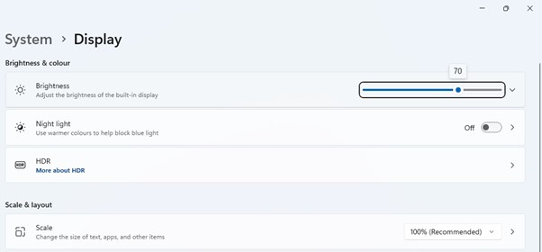 The Display settings page to reduce brightness in Windows 11 computer.